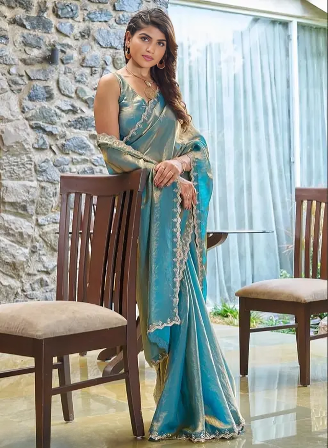 A saree of Fendy satin with zarkhad daimond with cutwork border.